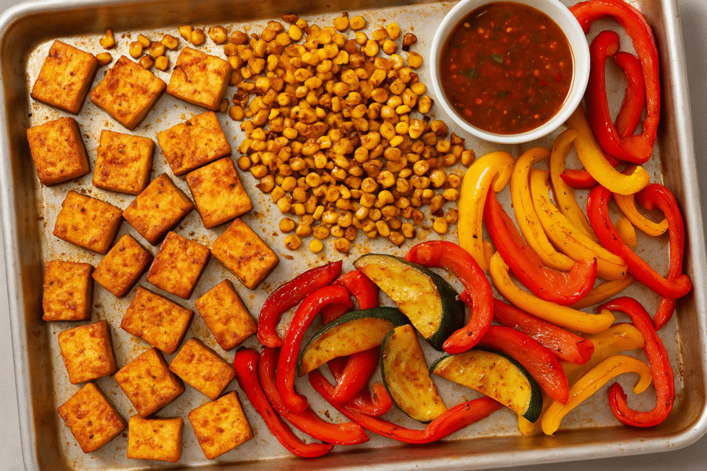 4) Crispy Tofu Sheet-Pan with Chili-Lime Corn & Peppers (27 g protein)​